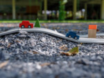 PlanToys Road and Rail – 19-Piece Flexible Rubber Track Set with 2 Cars, 3 Buildings and 3 Bushes, Ages 3+ - view 5