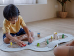 PlanToys Road and Rail – 19-Piece Flexible Rubber Track Set with 2 Cars, 3 Buildings and 3 Bushes, Ages 3+ - view 3