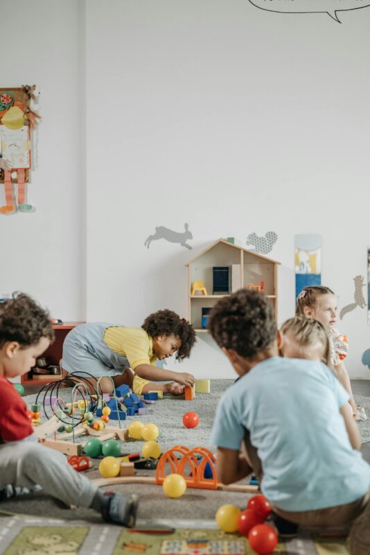 Children playing with toys together in a playroom